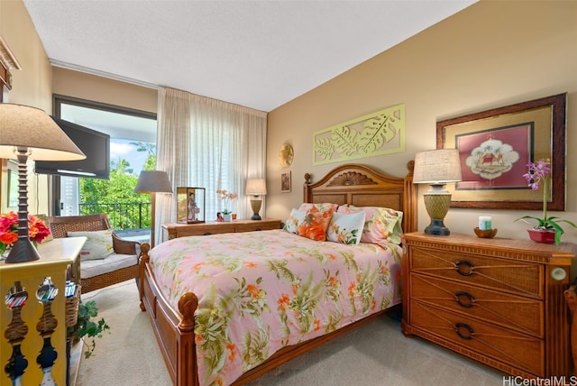 bedroom with light colored carpet and a textured ceiling