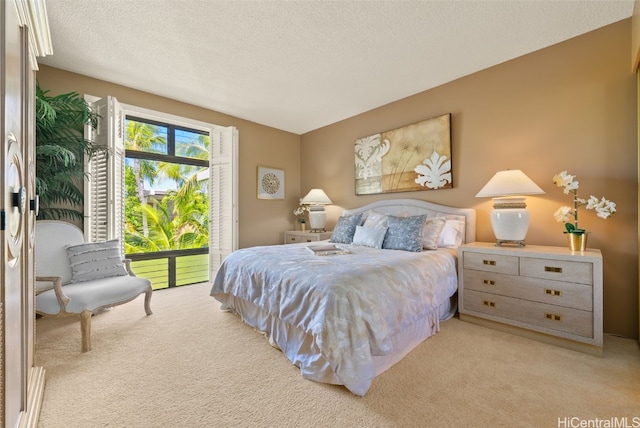 carpeted bedroom featuring a textured ceiling