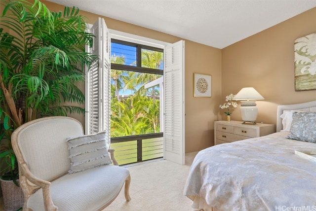 bedroom featuring a textured ceiling and light carpet