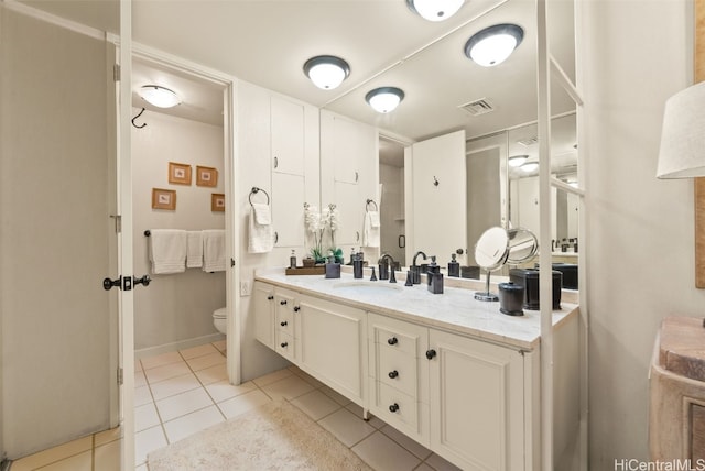 bathroom featuring tile patterned flooring, vanity, and toilet