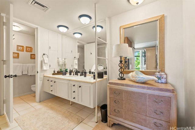 bathroom featuring tile patterned flooring, vanity, and toilet