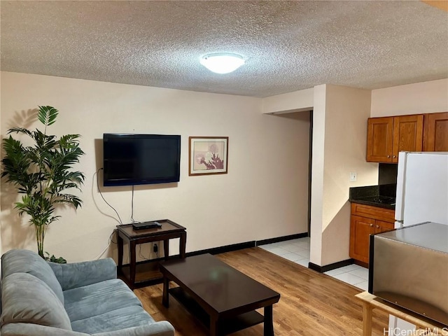 living room with light tile patterned flooring and a textured ceiling