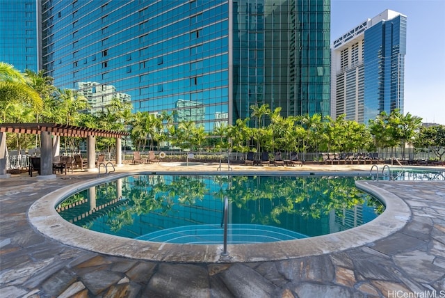 view of swimming pool with a pergola and a patio