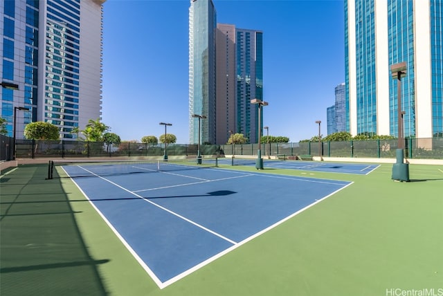 view of tennis court featuring basketball hoop