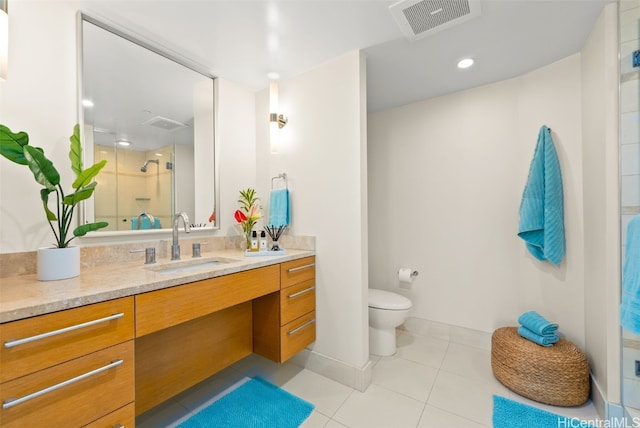 bathroom featuring tile patterned floors, vanity, toilet, and an enclosed shower