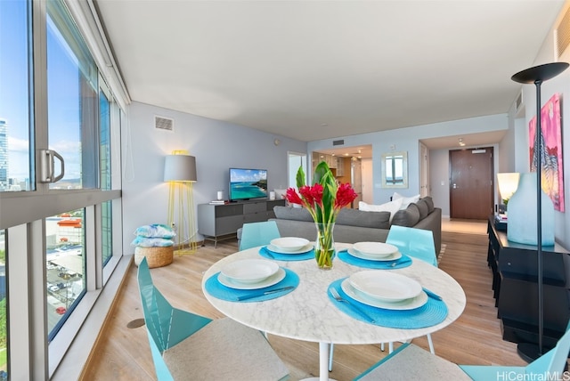 dining area with light hardwood / wood-style floors