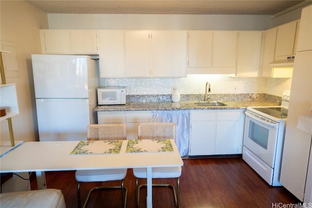 kitchen featuring white appliances, dark wood-type flooring, sink, range hood, and white cabinetry