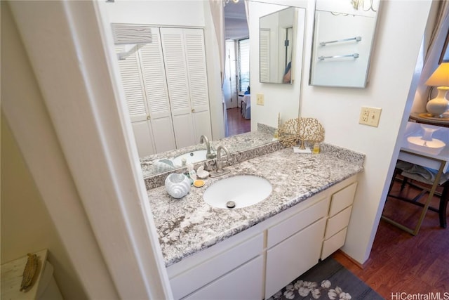 bathroom with hardwood / wood-style floors and vanity