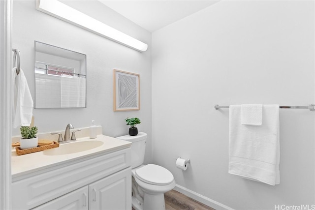 bathroom featuring hardwood / wood-style flooring, vanity, and toilet