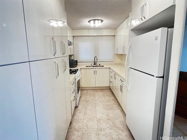 kitchen featuring sink, range hood, a textured ceiling, white appliances, and white cabinets