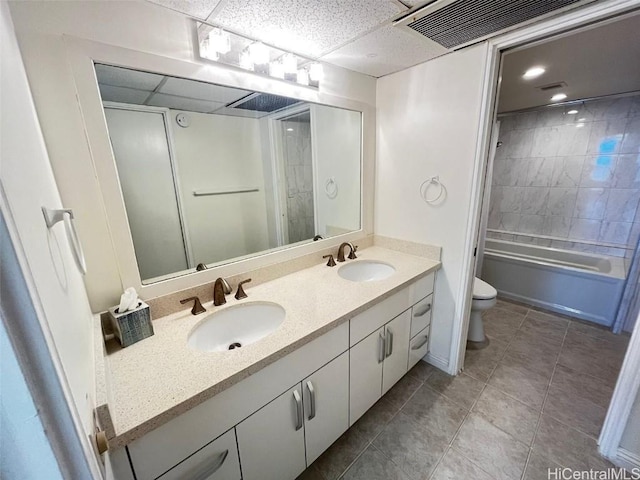 full bathroom featuring vanity, toilet, and tiled shower / bath combo