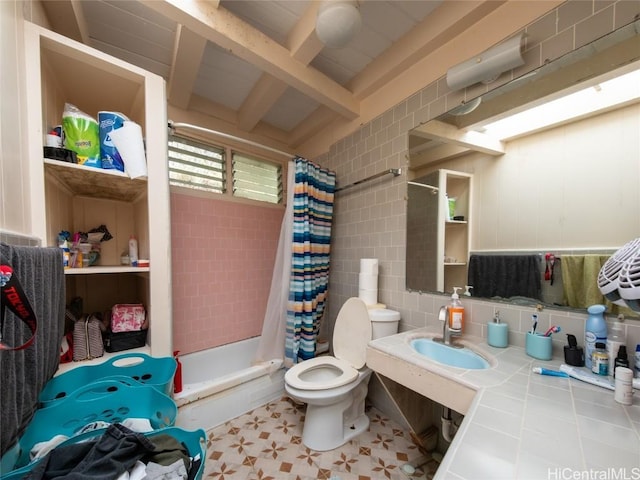 full bathroom with sink, toilet, tile walls, shower / tub combo with curtain, and beamed ceiling