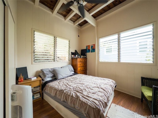 bedroom featuring beam ceiling, hardwood / wood-style flooring, multiple windows, and ceiling fan