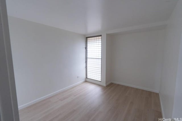 spare room featuring light wood-type flooring