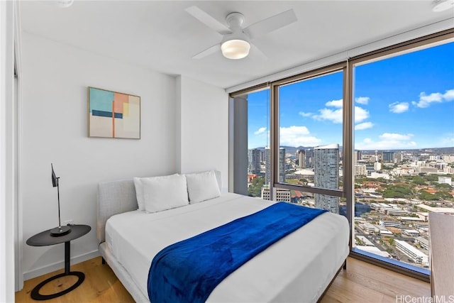 bedroom with hardwood / wood-style flooring and ceiling fan