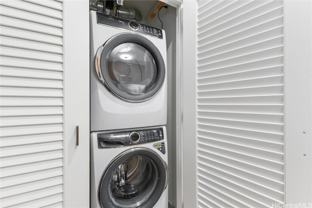 washroom featuring stacked washer / dryer