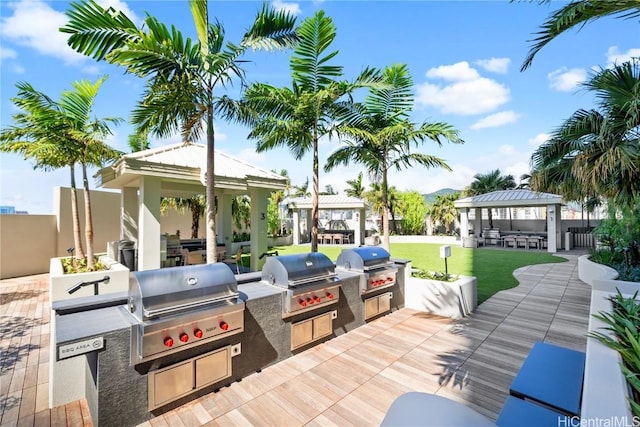 view of patio featuring a gazebo, area for grilling, and a grill