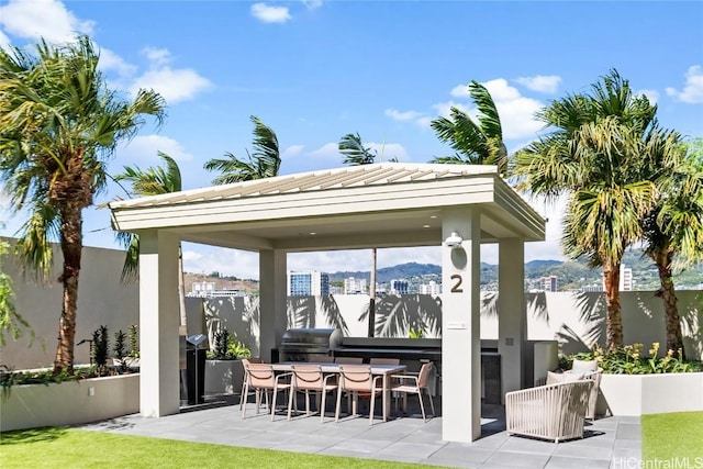 view of patio / terrace with a gazebo, a mountain view, and area for grilling