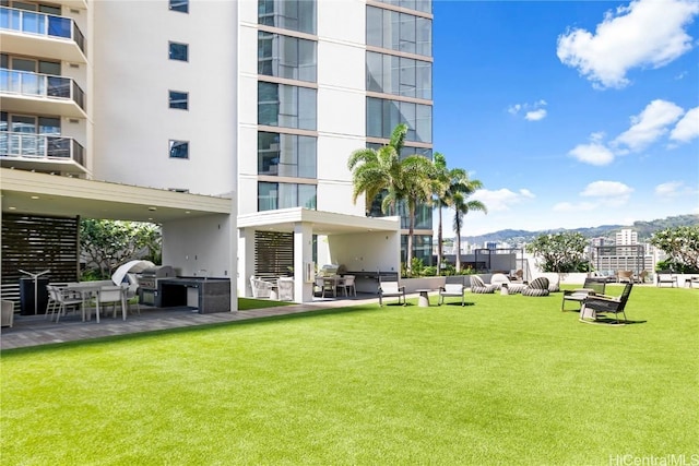 view of home's community with a lawn and a mountain view