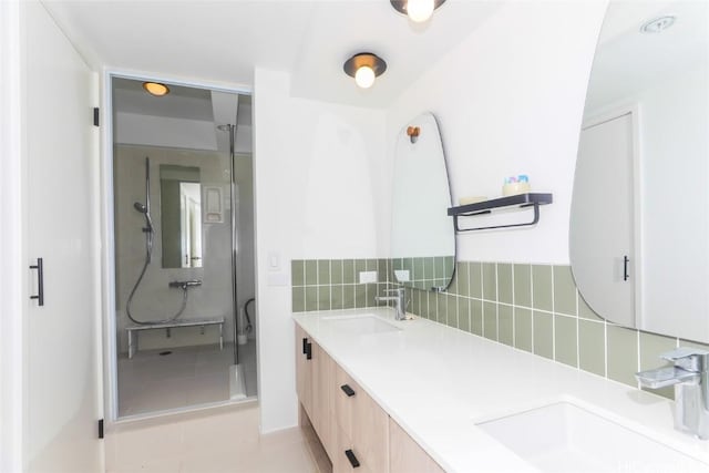 bathroom featuring a shower, decorative backsplash, tile patterned floors, and vanity