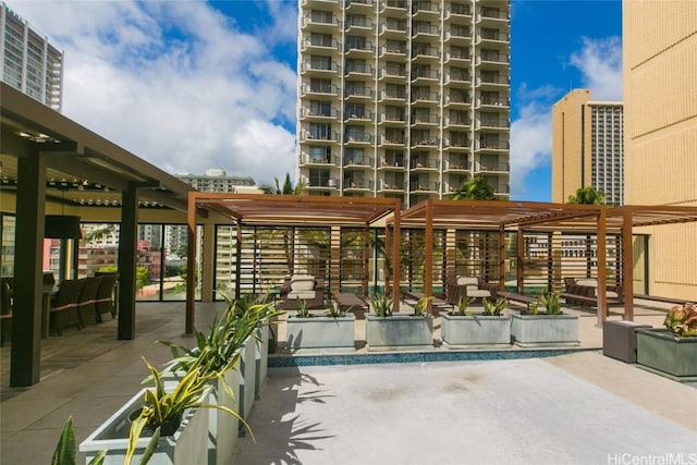 exterior space featuring a pergola, a patio area, and a swimming pool