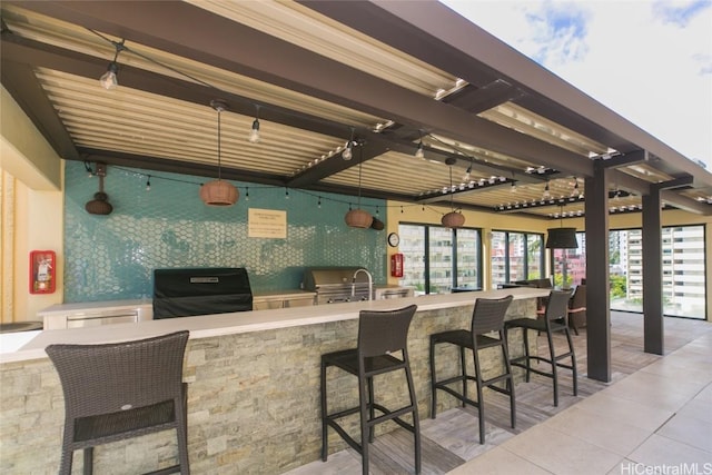 view of patio / terrace featuring an outdoor kitchen and a grill