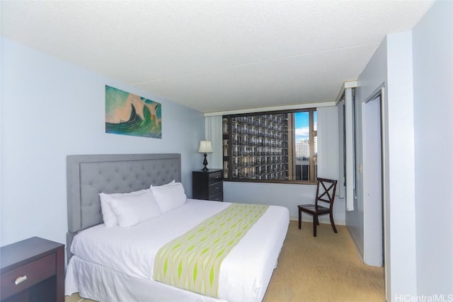 carpeted bedroom featuring a textured ceiling