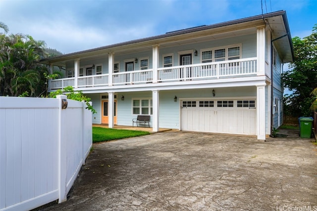 view of front of home featuring a balcony and a garage