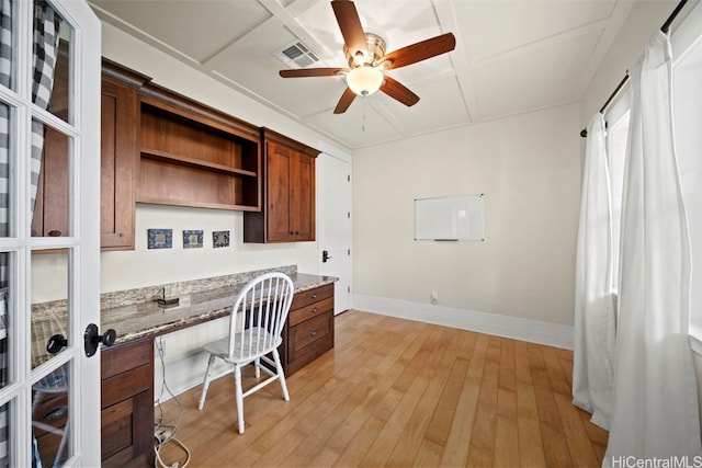 office featuring ceiling fan, built in desk, and light hardwood / wood-style flooring