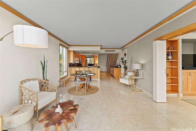 interior space featuring built in shelves and ornamental molding