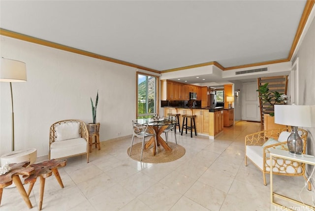 living area with a healthy amount of sunlight, baseboards, visible vents, and crown molding