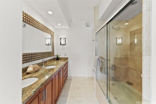 full bath featuring marble finish floor, double vanity, an enclosed shower, and a sink