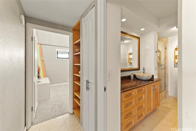 bathroom with tile patterned floors, vanity, and an enclosed shower