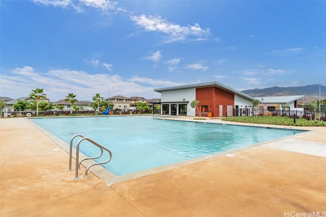 view of swimming pool featuring a mountain view and a patio