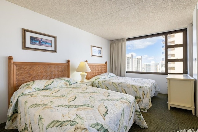 bedroom with carpet floors and a textured ceiling