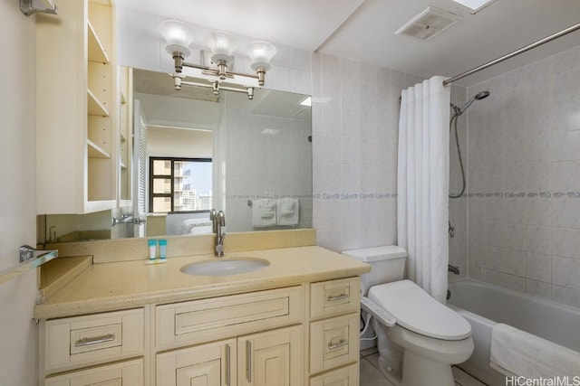 full bathroom featuring vanity, shower / bath combination with curtain, tile walls, and toilet