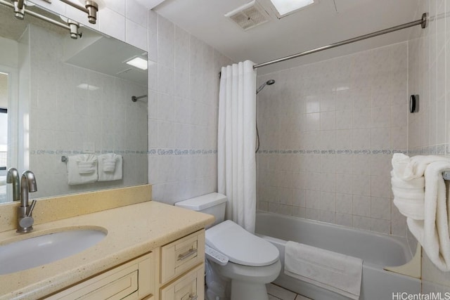 full bathroom featuring vanity, toilet, tile walls, and shower / tub combo