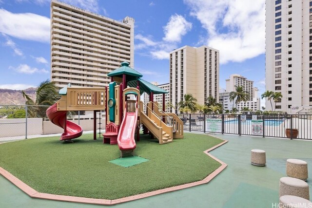 view of jungle gym with a community pool