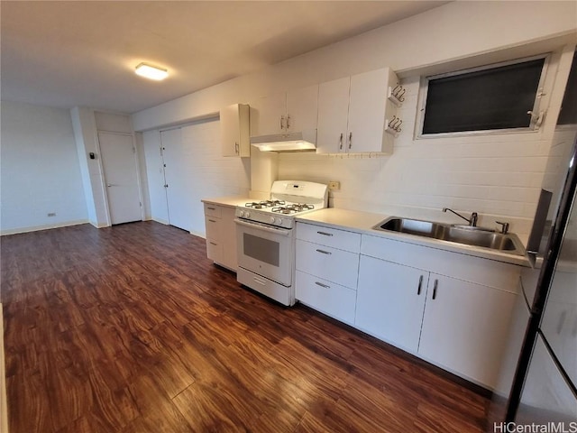 kitchen with white cabinets, sink, tasteful backsplash, white gas stove, and dark hardwood / wood-style flooring