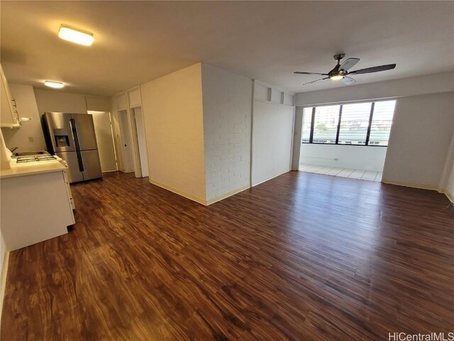 empty room with ceiling fan and dark hardwood / wood-style floors