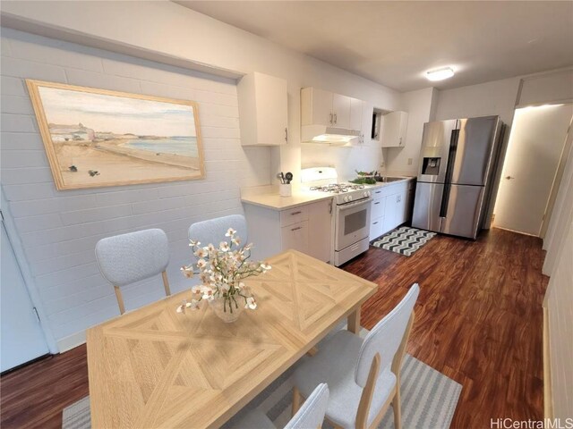 kitchen with white cabinetry, white range with gas stovetop, stainless steel refrigerator with ice dispenser, and dark wood-type flooring