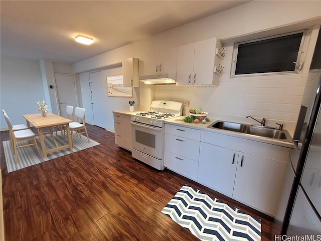 kitchen with dark hardwood / wood-style flooring, backsplash, white gas range, sink, and white cabinets