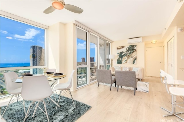 dining area with a healthy amount of sunlight, floor to ceiling windows, a wall mounted air conditioner, and light hardwood / wood-style flooring