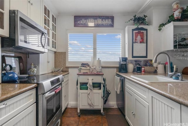 kitchen with white cabinets, appliances with stainless steel finishes, decorative backsplash, and sink