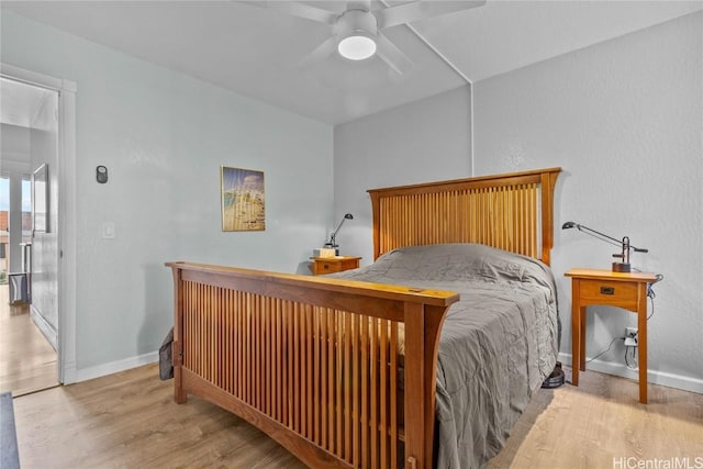 bedroom with ceiling fan and light hardwood / wood-style floors