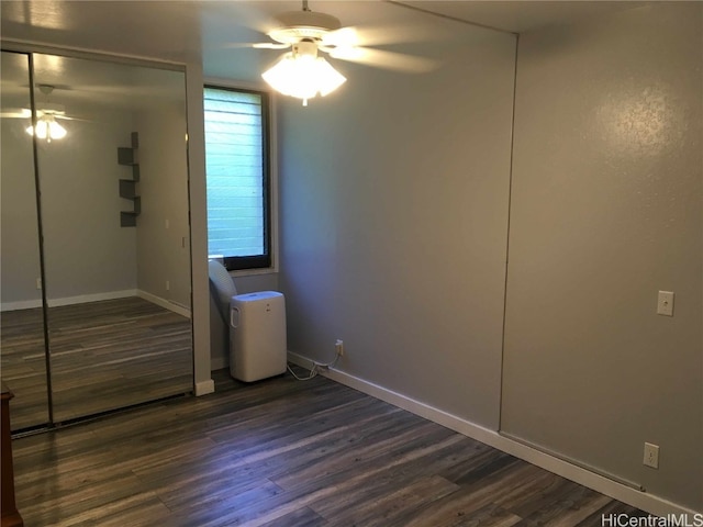 unfurnished bedroom featuring ceiling fan, a closet, and dark hardwood / wood-style floors