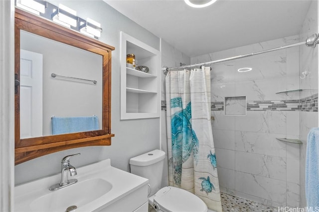 bathroom featuring a shower with curtain, toilet, built in features, and vanity