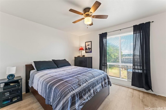 bedroom featuring multiple windows, ceiling fan, and light hardwood / wood-style floors