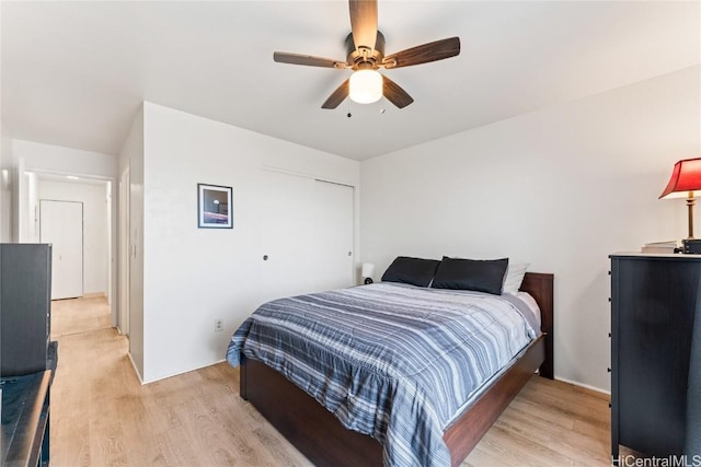 bedroom with ceiling fan and light hardwood / wood-style floors