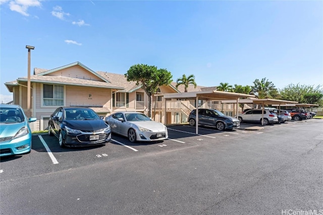 view of vehicle parking featuring a carport